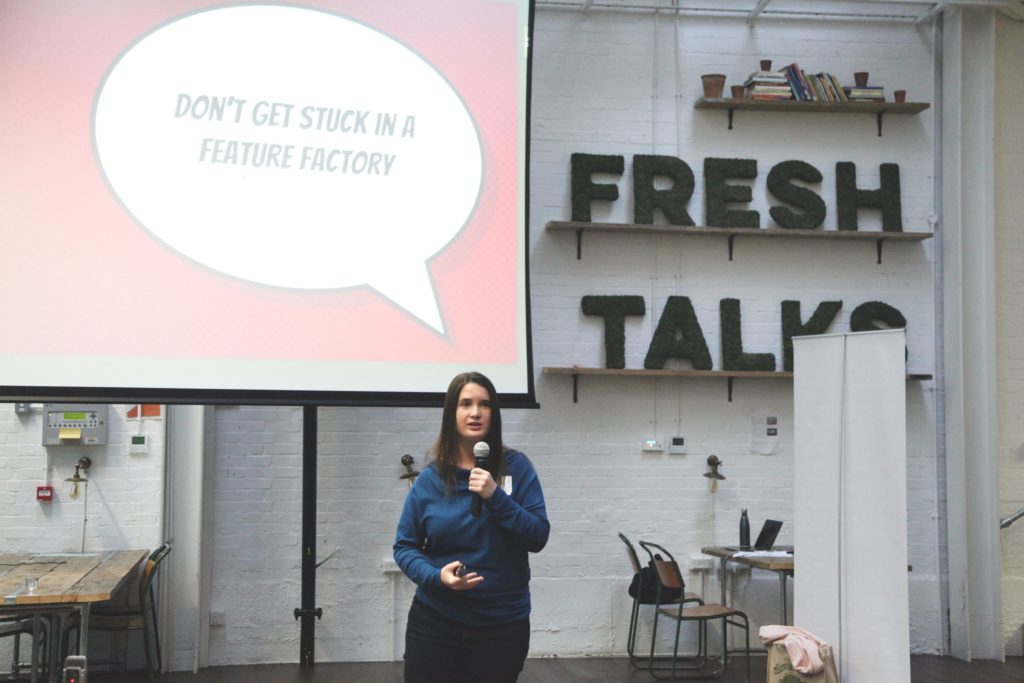 person speaking in front of presentation